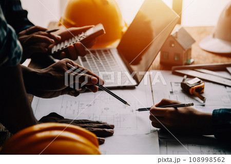 Construction and structure concept of Engineer or architect meeting for project working with partner and engineering tools on model building and blueprint in working site, contract for both companies. 108998562