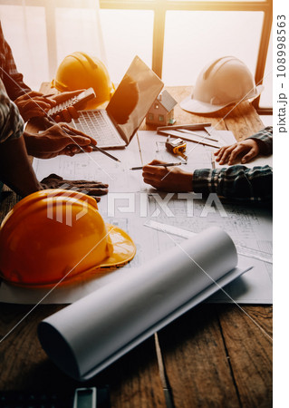 Construction and structure concept of Engineer or architect meeting for project working with partner and engineering tools on model building and blueprint in working site, contract for both companies. 108998563