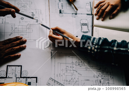 Construction and structure concept of Engineer or architect meeting for project working with partner and engineering tools on model building and blueprint in working site, contract for both companies. 108998565