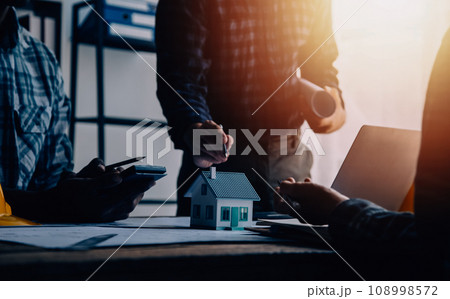 Construction and structure concept of Engineer or architect meeting for project working with partner and engineering tools on model building and blueprint in working site, contract for both companies. 108998572