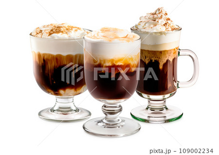 Set of Irish Coffee cocktails, adorned with a whipped cream and carrying the enticing aroma of freshly brewed coffee and smooth Irish whiskey. Isolated on white background Set of Irish Coffee cocktails, adorned with a whipped cream and carrying the enticing aroma of freshly brewed coffee and smooth Irish whiskey. Isolated on white background 109002234