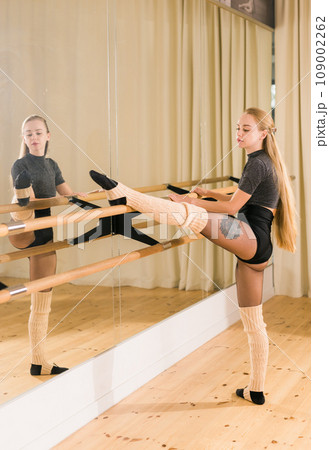 Ballerina in pointe pose. Beautiful ballet dancer stretching in class. Ballerina woman training Ballerina in pointe pose. Beautiful ballet dancer stretching in class. Ballerina woman training 109002262