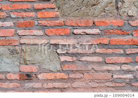 Red brick fortress wall in old Tbilisi in the sunset sunlight, idea for background and article about the city 109004014