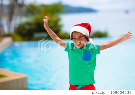Christmas vacation on tropical island. Xmas kids. 109004339