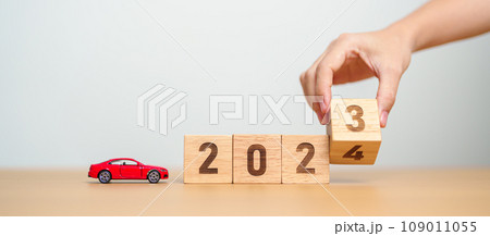 2023 flipping to 2024 year block with car model on table. Automobile Tax, Car Insurance, Financial, vehicle Repair and Maintenance and New Year concept 2023 flipping to 2024 year block with car model on table. Automobile Tax, Car Insurance, Financial, vehicle Repair and Maintenance and New Year concept 109011055