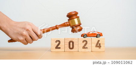 Car Law, Insurance, auto Tax, Auction and Bidding concepts. 2024 year block with crashed small toy car models with Judges gavel on desk in courthouse. Car Law, Insurance, auto Tax, Auction and Bidding concepts. 2024 year block with crashed small toy car models with Judges gavel on desk in courthouse. 109011062