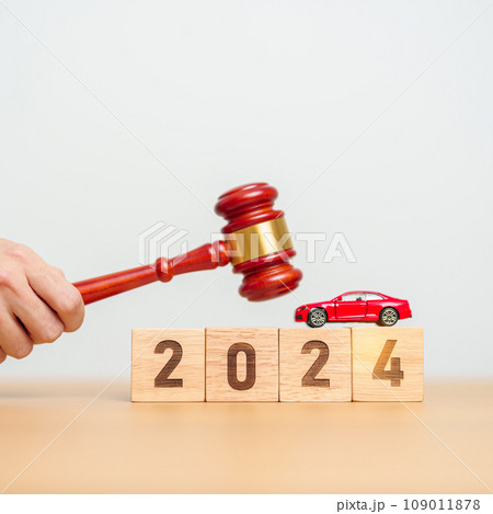 Car Law, Insurance, auto Tax, Auction and Bidding concepts. 2024 year block with crashed small toy car models with Judges gavel on desk in courthouse. Car Law, Insurance, auto Tax, Auction and Bidding concepts. 2024 year block with crashed small toy car models with Judges gavel on desk in courthouse. 109011878