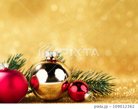 red and gold balls and fir on bokeh background red and gold balls and fir on bokeh background 109012362