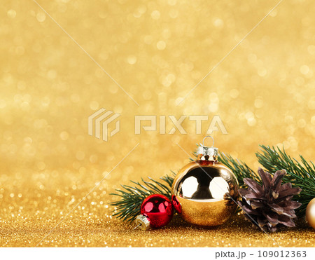 red and gold balls and fir on bokeh background red and gold balls and fir on bokeh background 109012363