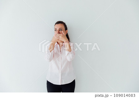 A woman covers her mouth and is silent A woman covers her mouth and is silent 109014083