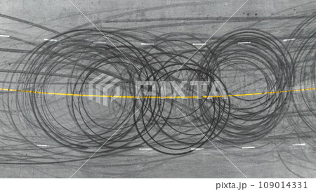 Aerial view tire track mark on asphalt tarmac road race track texture and background, Abstract background black tire track skid on asphalt road, Tire mark skid mark on asphalt road. Aerial view tire track mark on asphalt tarmac road race track texture and background, Abstract background black tire track skid on asphalt road, Tire mark skid mark on asphalt road. 109014331