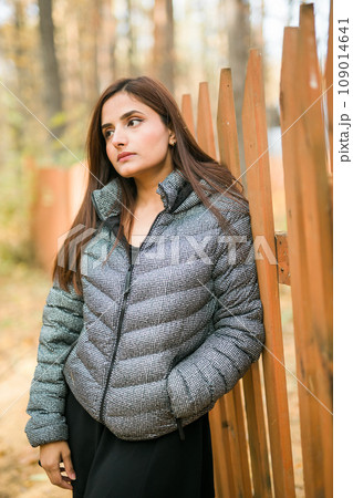 Close up portrait of pretty indian young woman enjoying warm autumn sunny day vacation outdoors. Generation z and gen z concept. Fall Season Close up portrait of pretty indian young woman enjoying warm autumn sunny day vacation outdoors. Generation z and gen z concept. Fall Season 109014641
