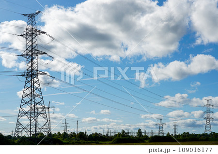 An industrial nature landscape with many high voltage power lines transmission pylons An industrial nature landscape with many high voltage power lines transmission pylons 109016177