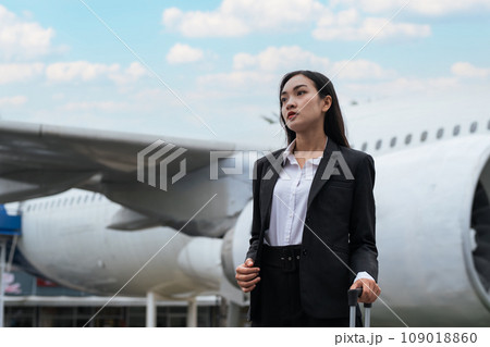 Tourist travel concept. young business woman holding the luggage at the airport 109018860