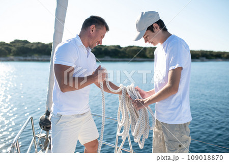 Dad and son spending time together on the yacht 109018870