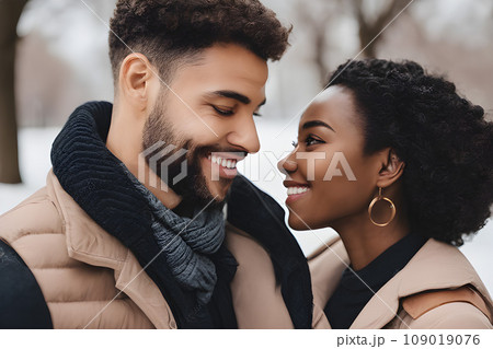 Close-up portrait of a happy man and woman of different nationalities in a park in spring. Multiracial romantic youth concept. Close-up portrait of a happy man and woman of different nationalities in a park in spring. Multiracial romantic youth concept. 109019076