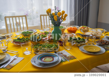 Easter. Traditional Polish Easter breakfast on a festive table with bright stylish decor and classic dishes on a yellow tablecloth 109020001