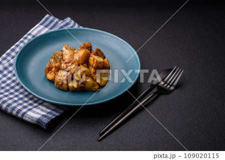 Delicious crispy fried potato wedges with salt, spices and herbs 109020115