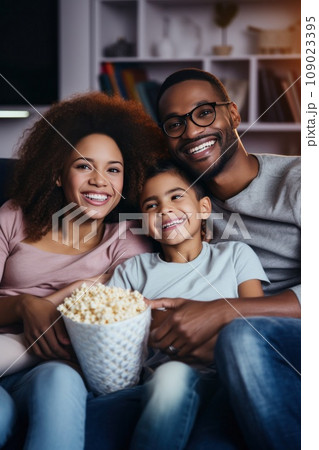 A mother, father, and their two children cuddled up on a fluffy blanket A mother, father, and their two children cuddled up on a fluffy blanket 109023395