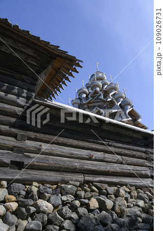 Fence of logs and stones around medieval wooden Church of the Transfiguration of the Lord in Karelia Fence of logs and stones around medieval wooden Church of the Transfiguration of the Lord in Karelia 109026731