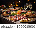 Light snacks in a plate on a buffet table. Assorted mini canapes, delicacies and snacks, restaurant food at event. A gala reception. Decorated delicious table for a party goodies. 109026930