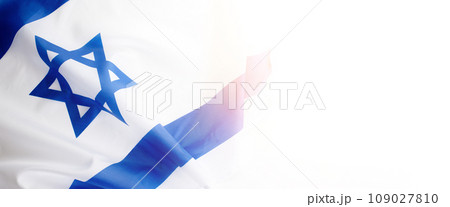 Banner with Official flag of Israel on a white background and copy space. Israeli flag for Jewish Holidays and independence day. 109027810