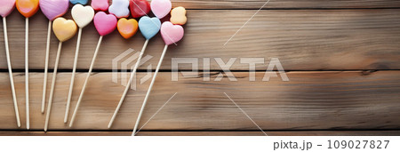 Heart shaped candy lollipop for valentines day on a wooden table. Heart shaped candy lollipop for valentines day on a wooden table. 109027827