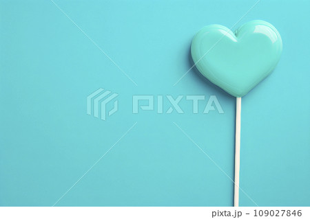 Heart shaped candy lollipop for valentines day on blue background 109027846