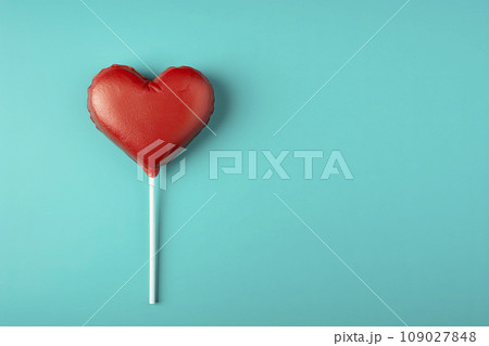 Heart shaped candy lollipop for valentines day on blue background 109027848