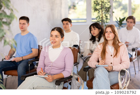 Group of high school students listening to lecture in auditorium 109028792