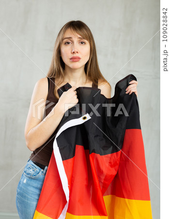 Young sad pretty woman displaying flag of germany 109028842