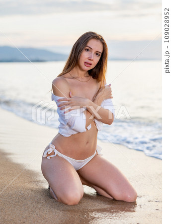 Close up portrait of beautiful young woman on the beach. Young caucasian female model on sea shore 109028952