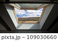 View from the open window at attic on blue sky with clouds 109030660