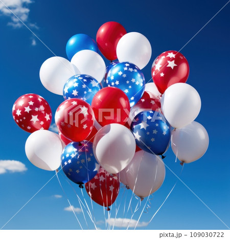 balloons in patriotic colors floating against a bright blue sky 109030722