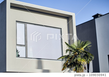 Large mirrored window. Modern elements in modern architecture. Architectural details of a modern apartment building. With space to copy. High quality photo 109030941