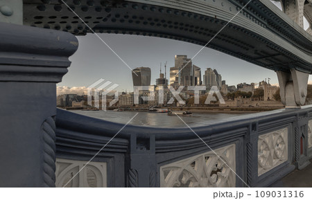 The skyscrapers in the business district of London and the River Thames. Looking through Structural and balustrade of the Tower Bridge. The skyscrapers in the business district of London and the River Thames. Looking through Structural and balustrade of the Tower Bridge. 109031316