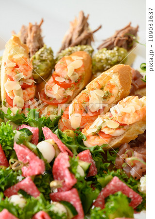 Appetizer with lettuce and canapes with tomato and sausage Appetizer with lettuce and canapes with tomato and sausage 109031637