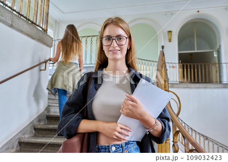 Portrait of young teenage girl student posing inside an educational building Portrait of young teenage girl student posing inside an educational building 109032423