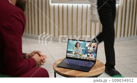 Associate calling management team on videoconference call to share results from important conference. White collar worker travelling on work trip to ensure future partnership. Handheld shot. Associate calling management team on videoconference call to share results from important conference. White collar worker travelling on work trip to ensure future partnership. Handheld shot. 109034912