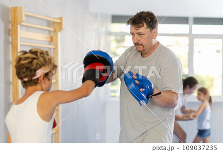 Father and son training boxing in studio 109037235