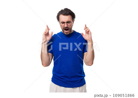 young handsome brunette man with a beard in a corporate color t-shirt young handsome brunette man with a beard in a corporate color t-shirt 109051866