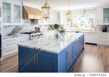 Interior of modern luxurious kitchen classic style. White and blue cabinets with gilded handles, kitchen island with white marble countertop, built-in home appliances, golden pendant lights. Interior of modern luxurious kitchen classic style. White and blue cabinets with gilded handles, kitchen island with white marble countertop, built-in home appliances, golden pendant lights. 109054188