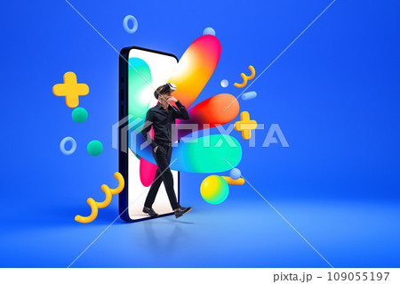Creative collage with photo of man in virtual reality glasses going out of 3d model of smartphone with colorful splashes and figures isolated blue background. 109055197