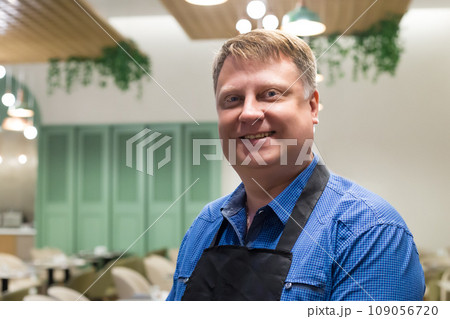 Portrait of a male waiter, blond, 40-44 years old, close-up Portrait of a male waiter, blond, 40-44 years old, close-up 109056720