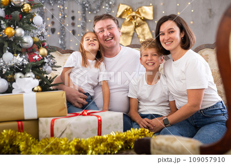 Portrait of parents with son and daughter during christmas celebration at home 109057910