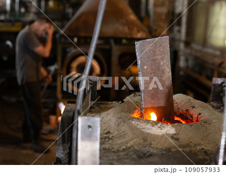 Ferrous metal billet is melted in an induction furnace closeup Ferrous metal billet is melted in an induction furnace closeup 109057933