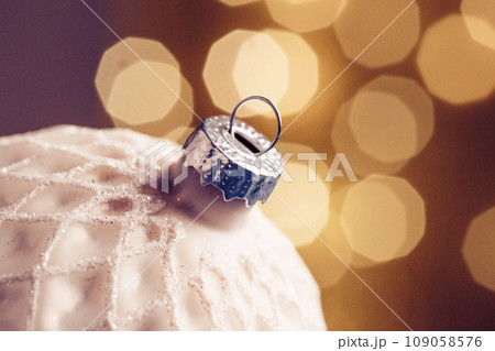 Christmas ball close-up against a background of sparkling garlands 109058576