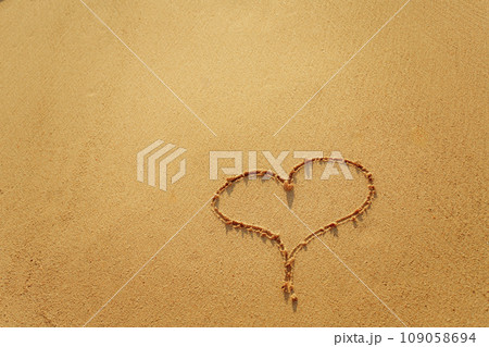 Heart on beach with sunset. Romantic composition. Heart on beach with sunset. Romantic composition. 109058694