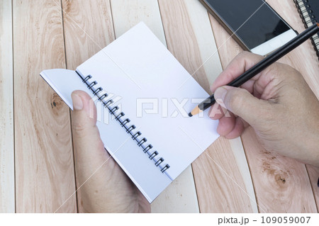 Businessman hands with pen writing notebook on office desk. Copy space. Businessman hands with pen writing notebook on office desk. Copy space. 109059007