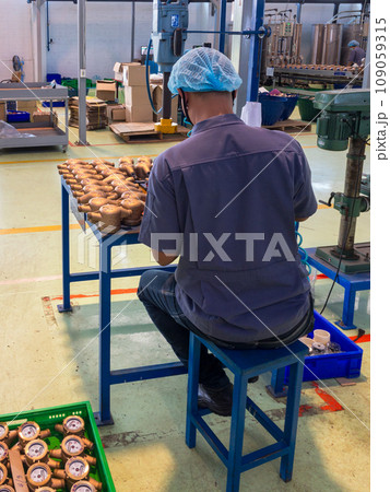 Behind the male worker who is assembling a water meter Behind the male worker who is assembling a water meter 109059315
